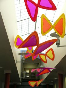A colorful display of kites in the lobby.