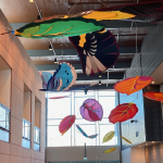 A colorful display of kites in the lobby.
