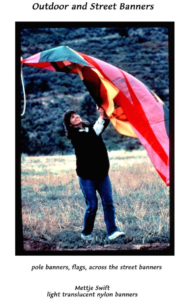 A woman holding onto a kite in the middle of nowhere.