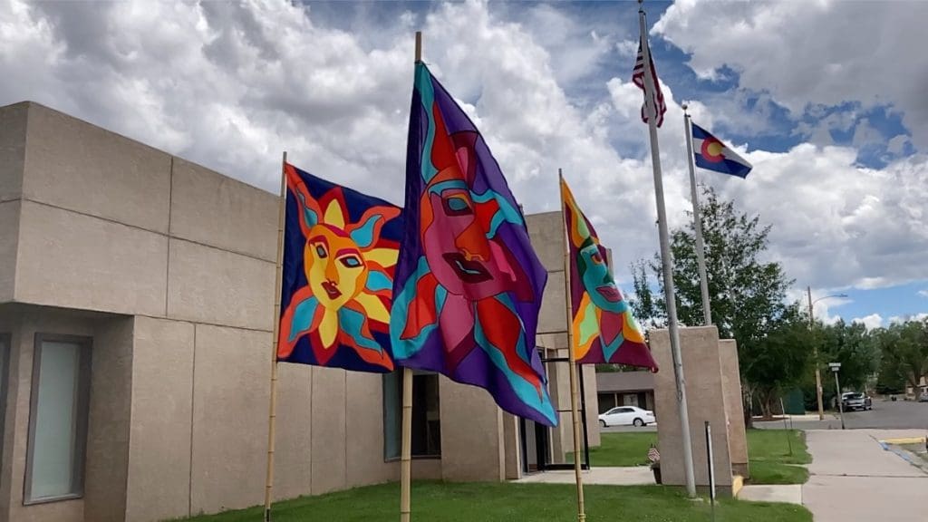 A group of flags that are on top of poles.