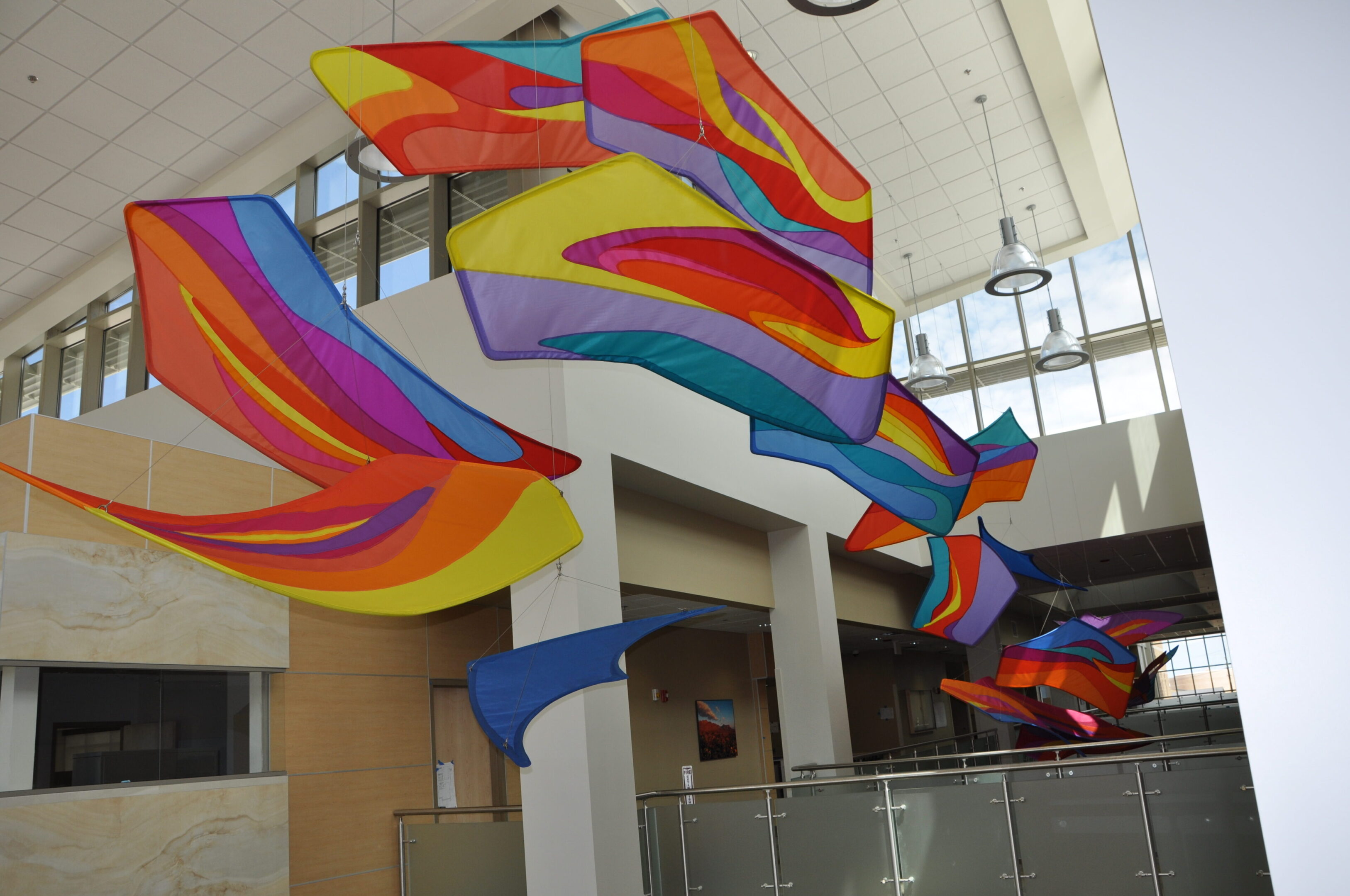 A colorful building with many kites hanging from the ceiling.