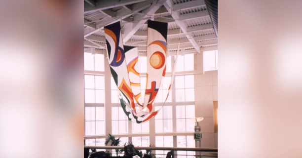 A large room with many windows and some hanging flags