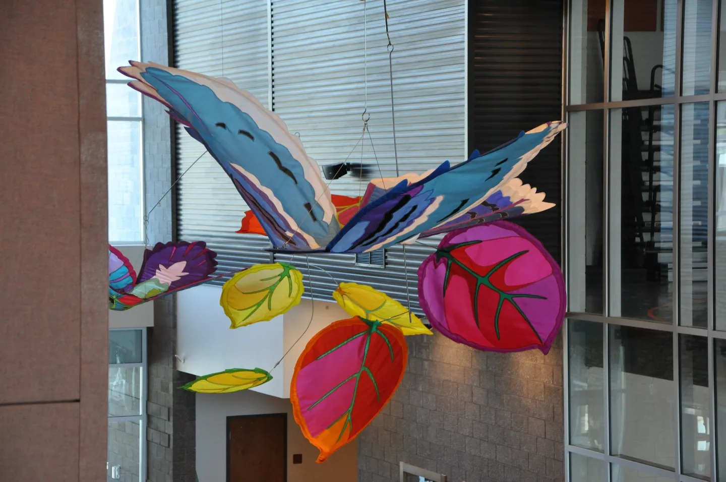 A colorful butterfly made of paper hanging from the ceiling.