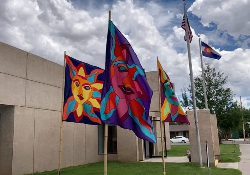 A group of flags that are on top of poles.