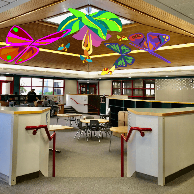 A room with tables and chairs, and colorful decorations.