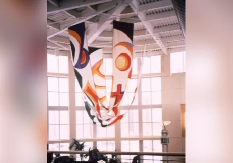 A large room with many windows and some hanging flags